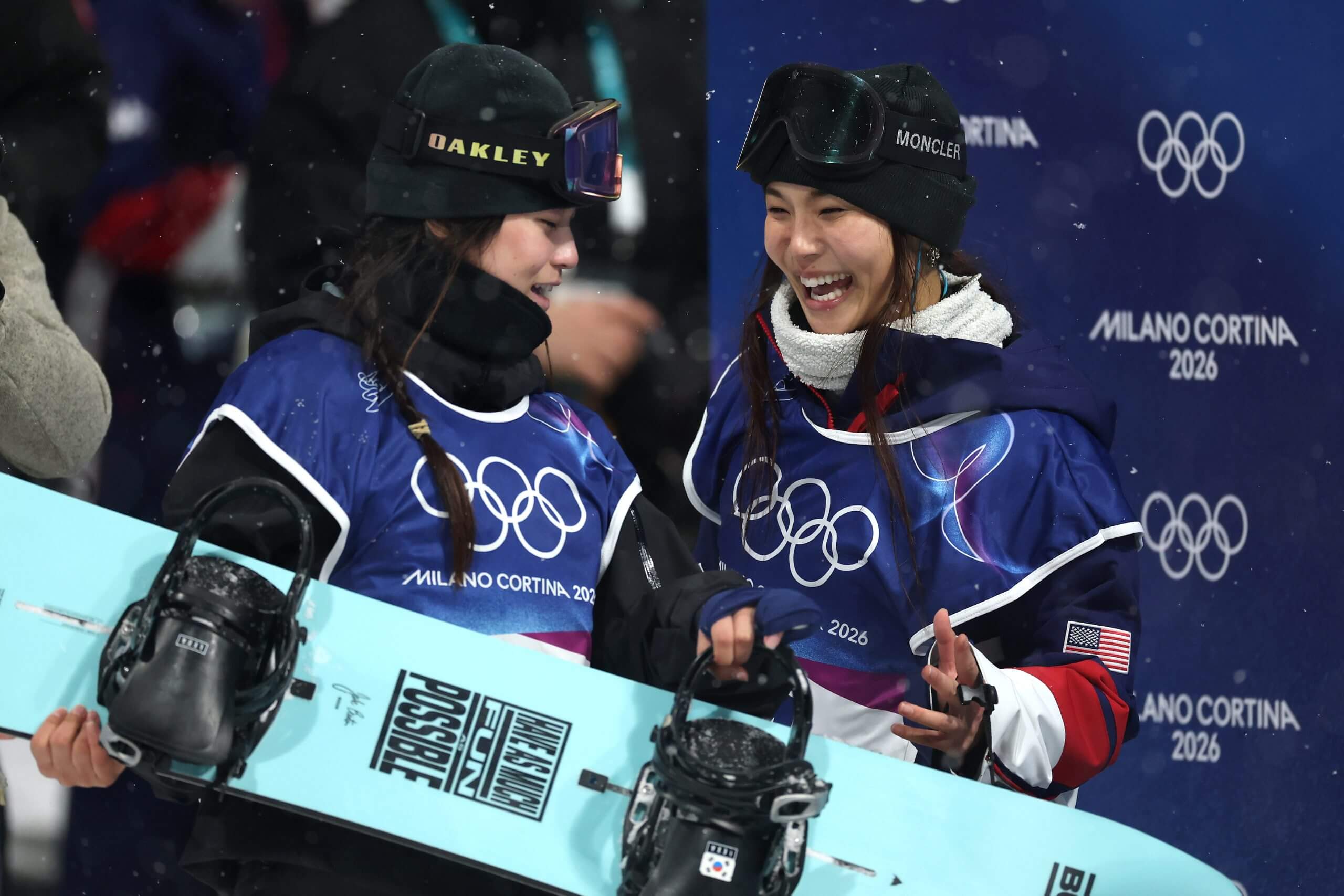 Gold medalist Choi Gaon of Team Republic of Korea laughs with silver medalist Chloe Kim of the United States after competing in the women’s snowboard halfpipe final.
