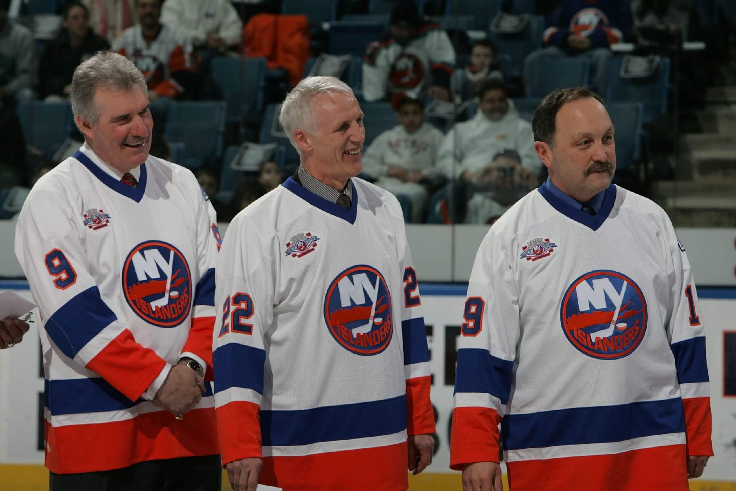 Clark Gillies, Mike Bossy and Bryan Trottier smile in Islanders jerseys in a pre-game ceremony.