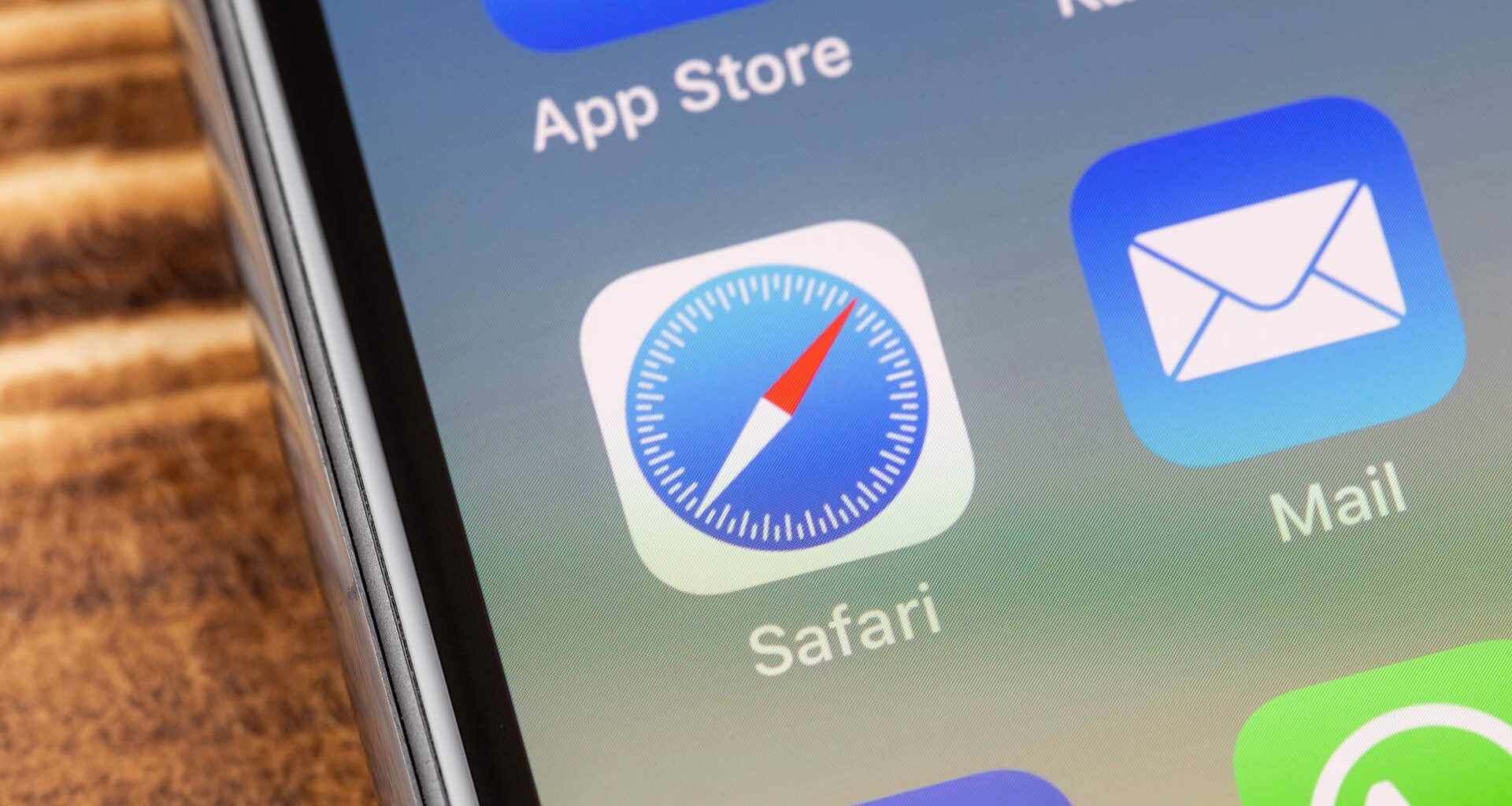 An image of an iPhone screen showing the Safari app icon in the center