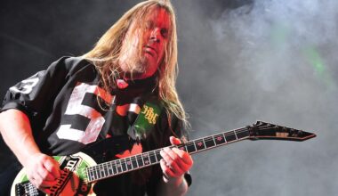 Jeff Hanneman of Slayer performing live on stage, playing guitar with intense energy.