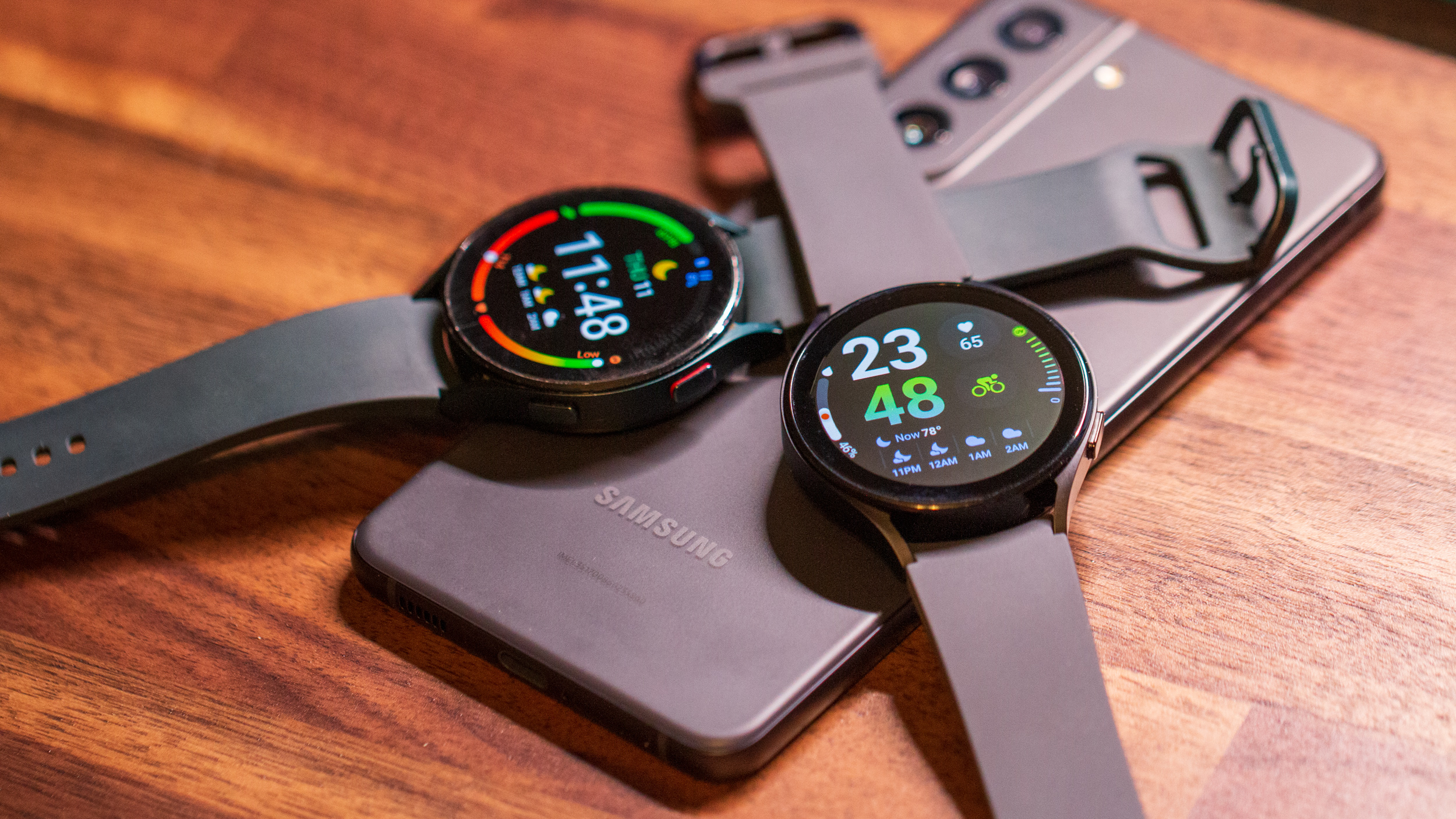 Samsung Galaxy Watch 5 vs Galaxy Watch 4 overlapping and sitting on top of Galaxy S21 FE