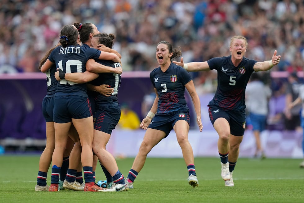 The United States team celebrate after winning the women's bronze medal Rugby Sevens match...