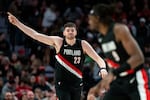 Portland Trail Blazers center Donovan Clingan (23) points towards the crowd after making a basket during the second half of an NBA basketball game against the Memphis Grizzlies on Saturday, Feb. 7, 2026, in Portland, Ore.