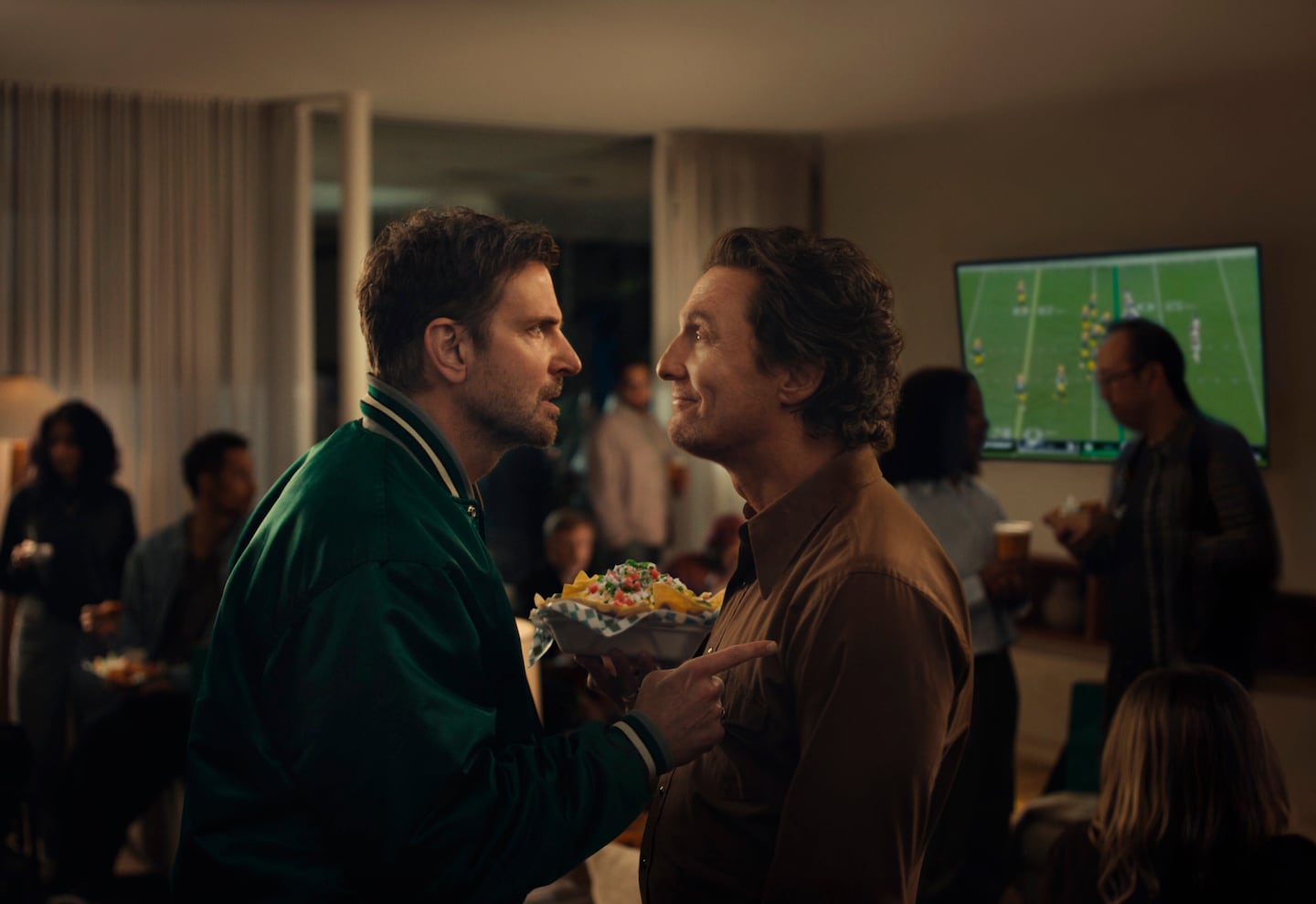 Bradley Cooper (left) and Matthew McConaughey in a scene from an Uber Eats ad set to run during Super Bowl LX.