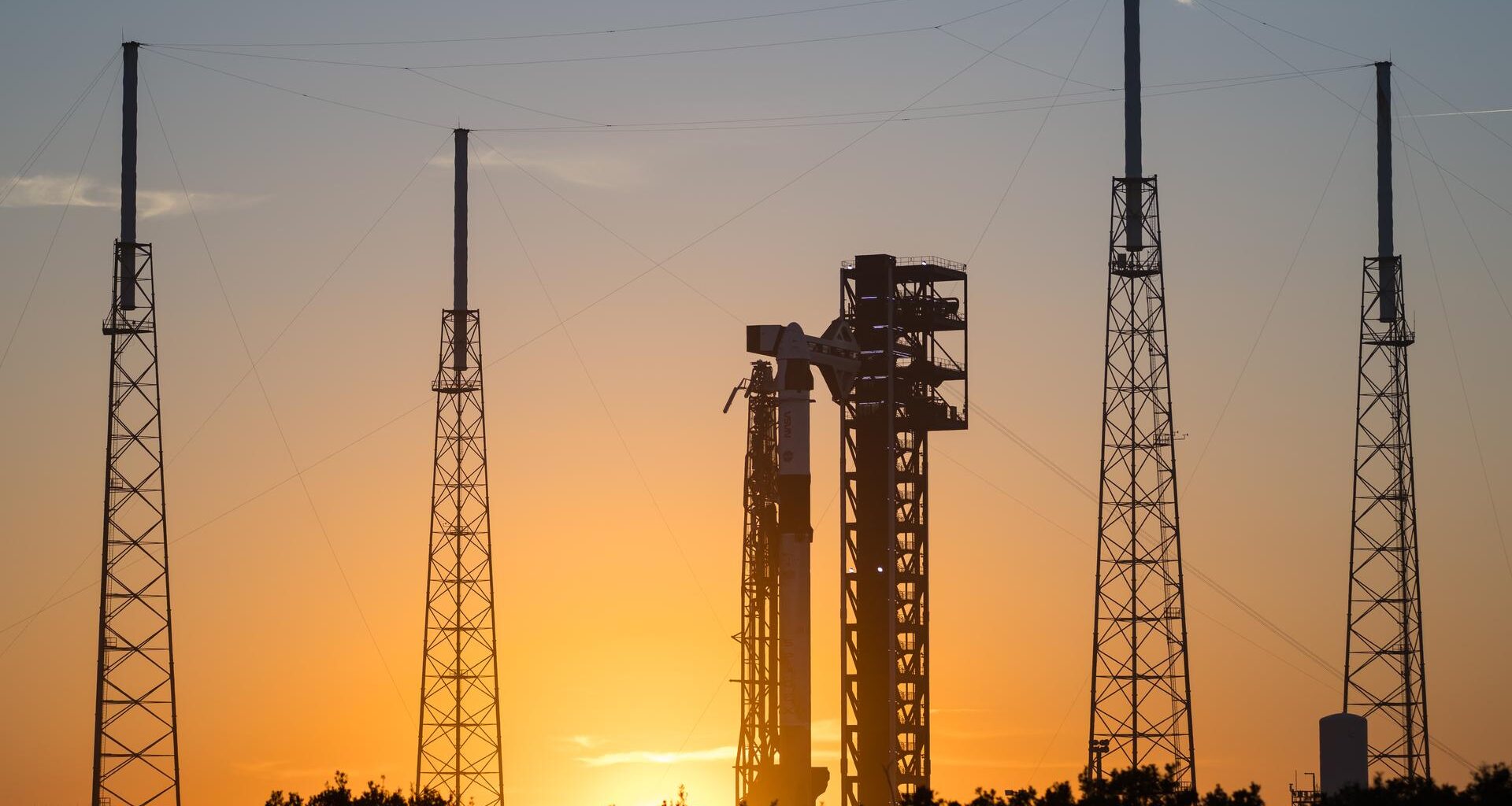 Image shows the sunset while a SpaceX rocket and SpaceX Dragon spacecraft stand vertical for NASA's SpaceX Crew-12 mission at Space Launch Complex 40 at Cape Canaveral Space Force Station in Florida on Tuesday, Feb. 10, 2026. Photo credit: NASA/Aubrey Gemignani