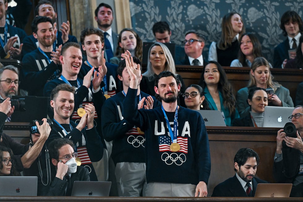 Members of the United States' Olympic gold medal hockey team enter the gallery as President...