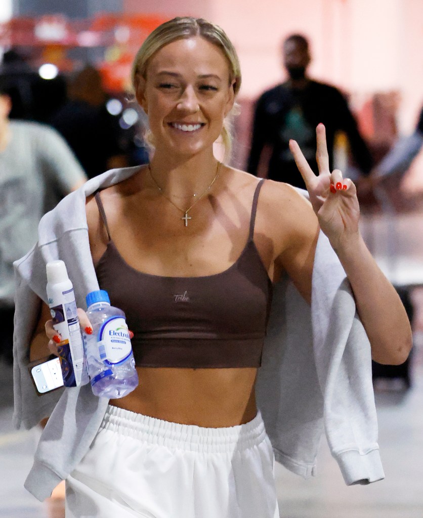 Sophie Cunningham smiling and making a peace sign as she arrives at the Barclays Center.