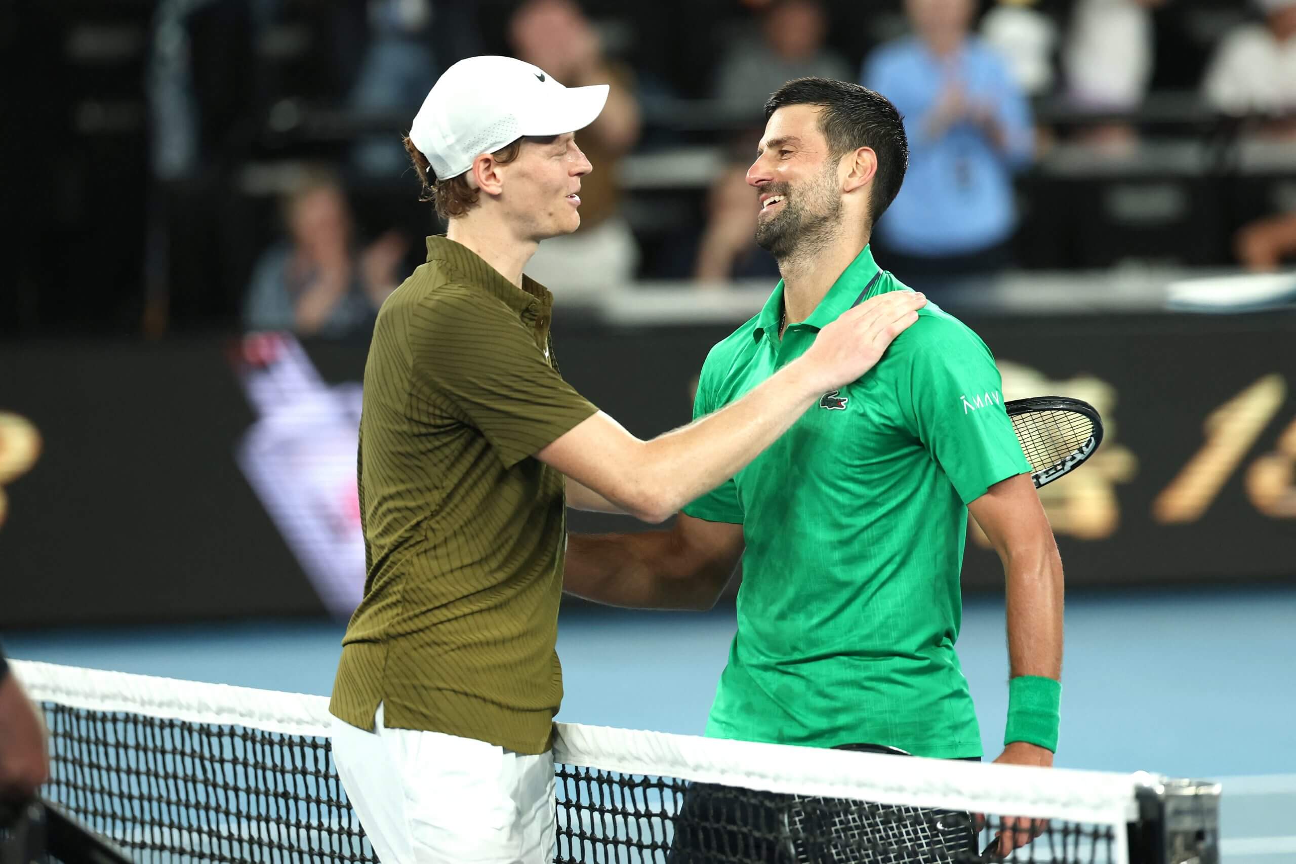 Jannik Sinner (left) and Novak Djokovic (right) meet at the net after their Australian Open semifinal.