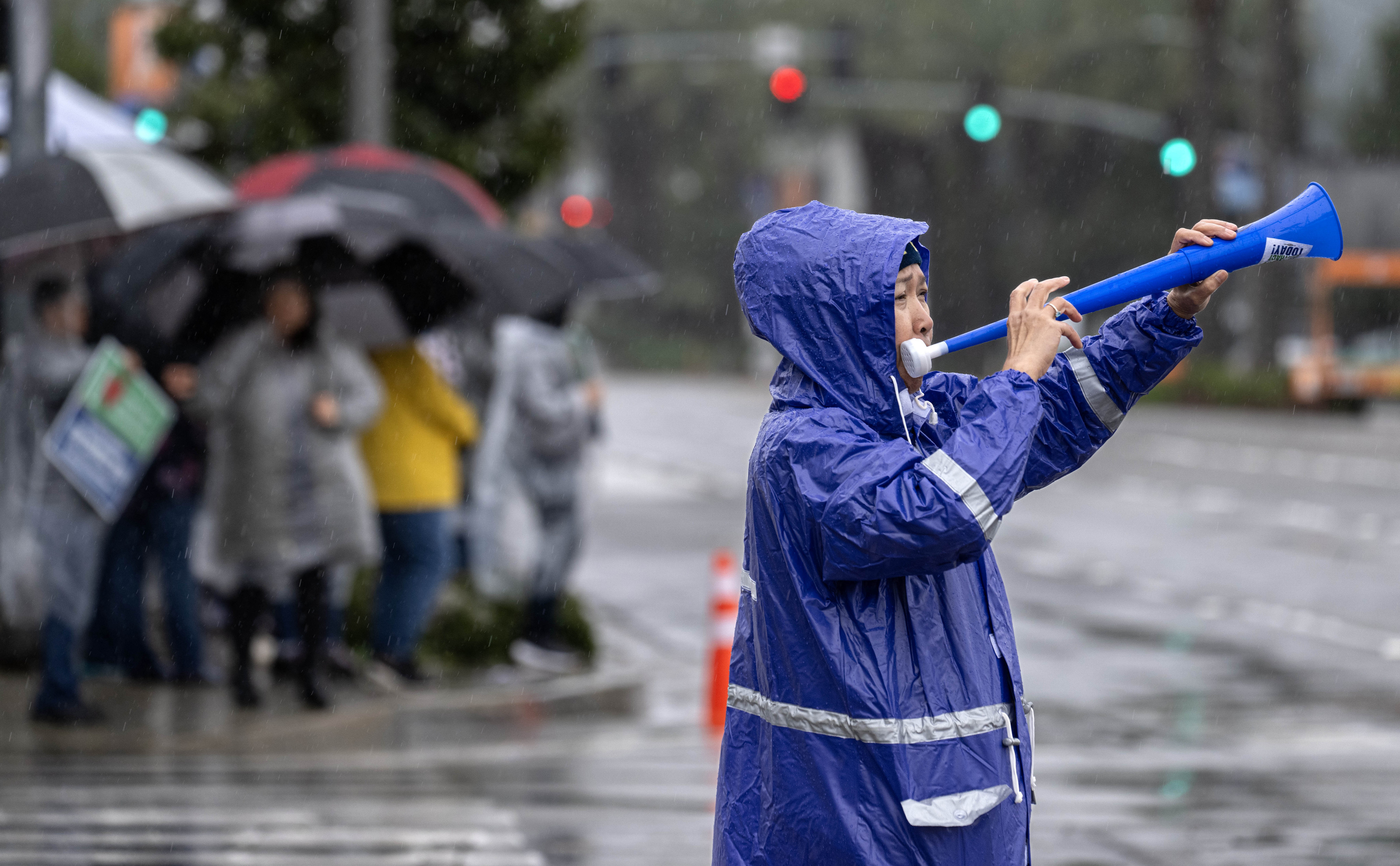 Emergency room nurse Teer Kina sounds the horn as she...