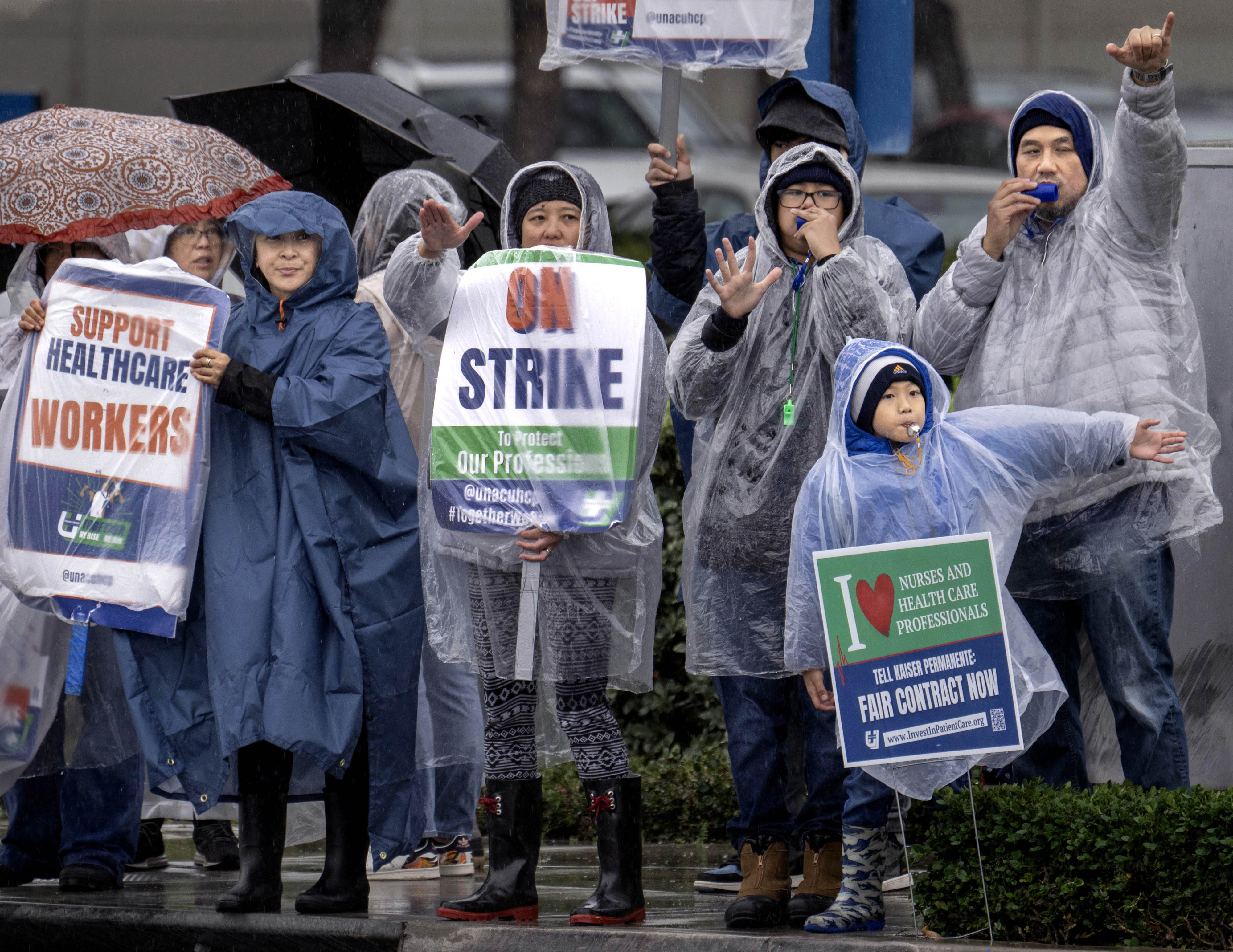 Despite a downpour, Kaiser Permanente nurses and health care workers...