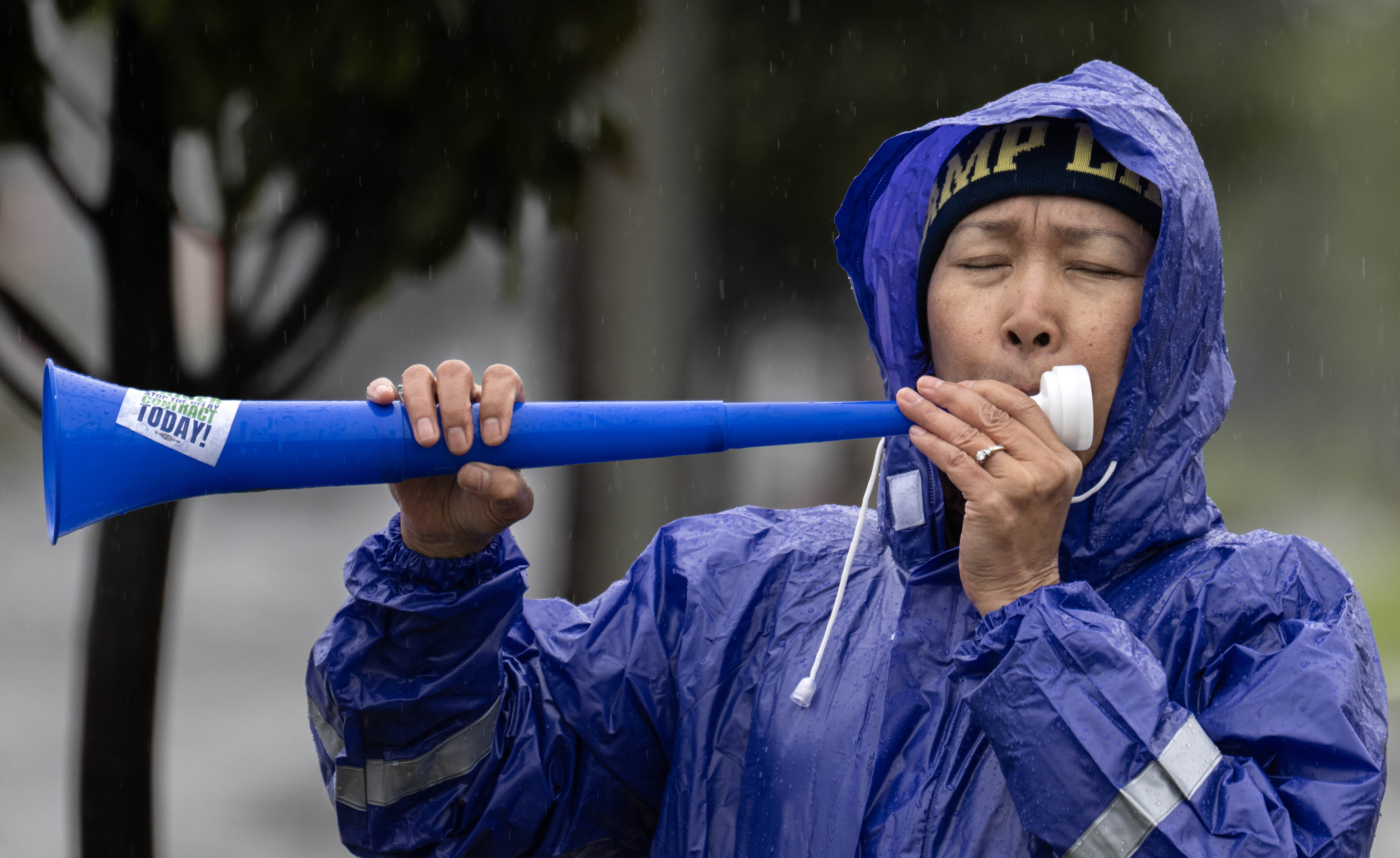 Emergency room nurse Teer Kina sounds the horn as she...