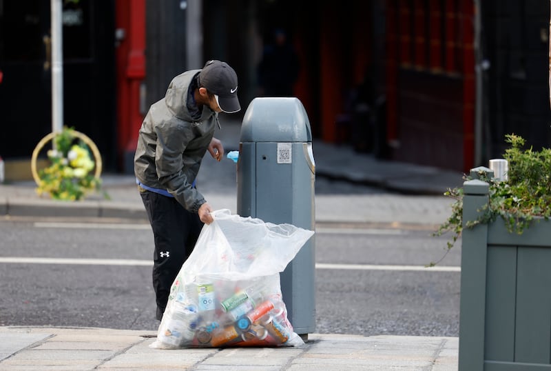 A man collecting bottles and cans from a bin in Dame Street, Dublin. Photograph: Nick Bradshaw