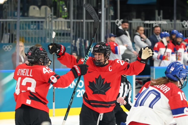 Kristin O'Neill of Team Canada celebrates with teammate Marie-Philip Poulin