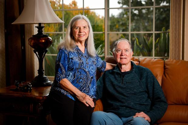 Patti and Myron Monroe pose for a photo inside their home on Wednesday, Feb. 18, 2026 in Poway, California. (Meg McLaughlin / The San Diego Union-Tribune)