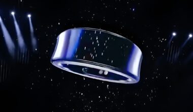 A metallic ring-shaped object is suspended in a dark space with spotlight illumination and a starry background.