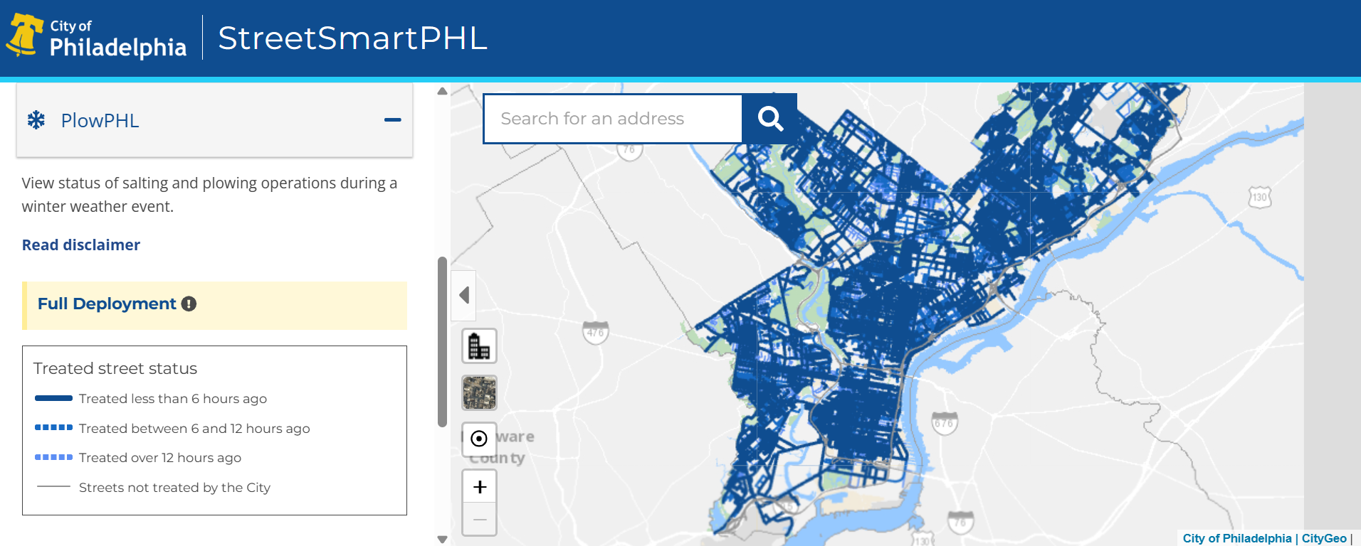Screenshot of the City of Philadelphia StreetSmartPHL PlowPHL dashboard showing a citywide map with most streets highlighted in dark blue to indicate recent plowing or salting activity. A legend on the left explains treated street status by time frame, and a search bar appears at the top for locating specific addresses.