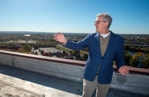 Bruce Simons, a principal in the West Hartford-based Simons Real Estate Group and one of the partners in Port Eastside, shows the views from 111 Founders Plaza in East Hartford, on Friday, Oct. 18, 2024. The Port Eastside group is redeveloping the East Hartford Side of the Connecticut River. (Aaron Flaum/ Hartford Courant)