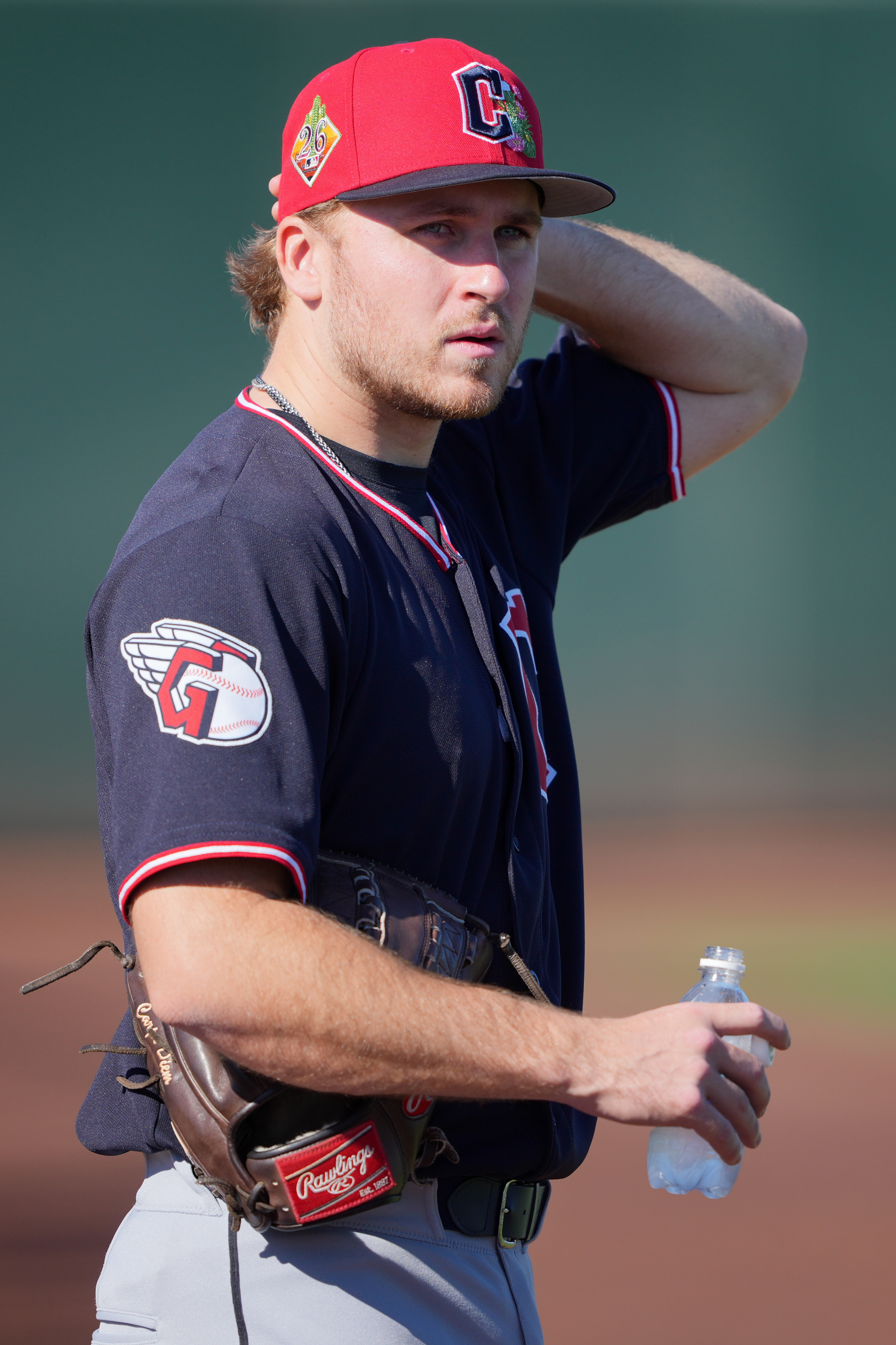 Cleveland Guardians pitcher Gavin Williams watches work outs during spring...