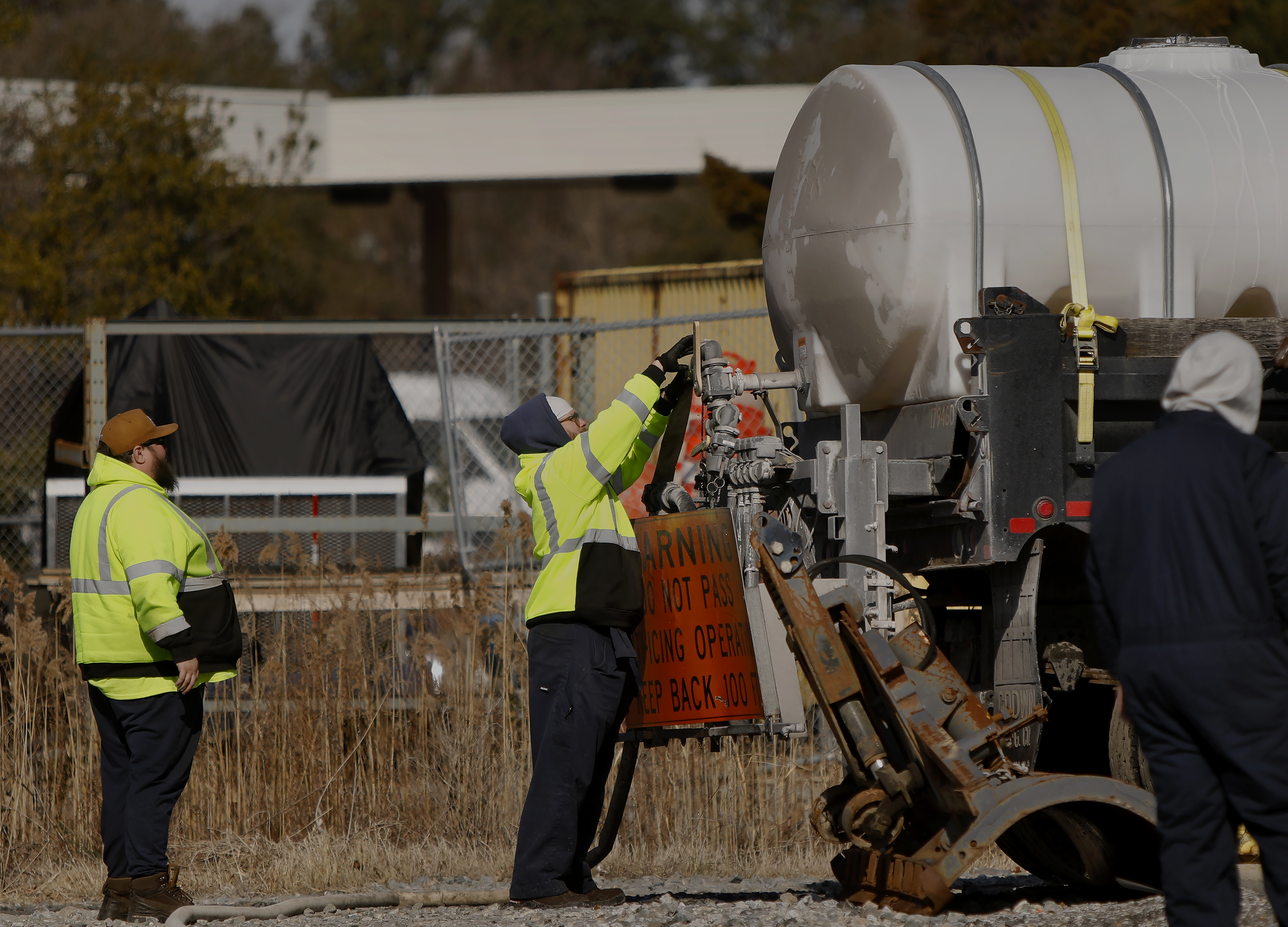 Virginia Beach Public Works employees prepare brine to be spread...