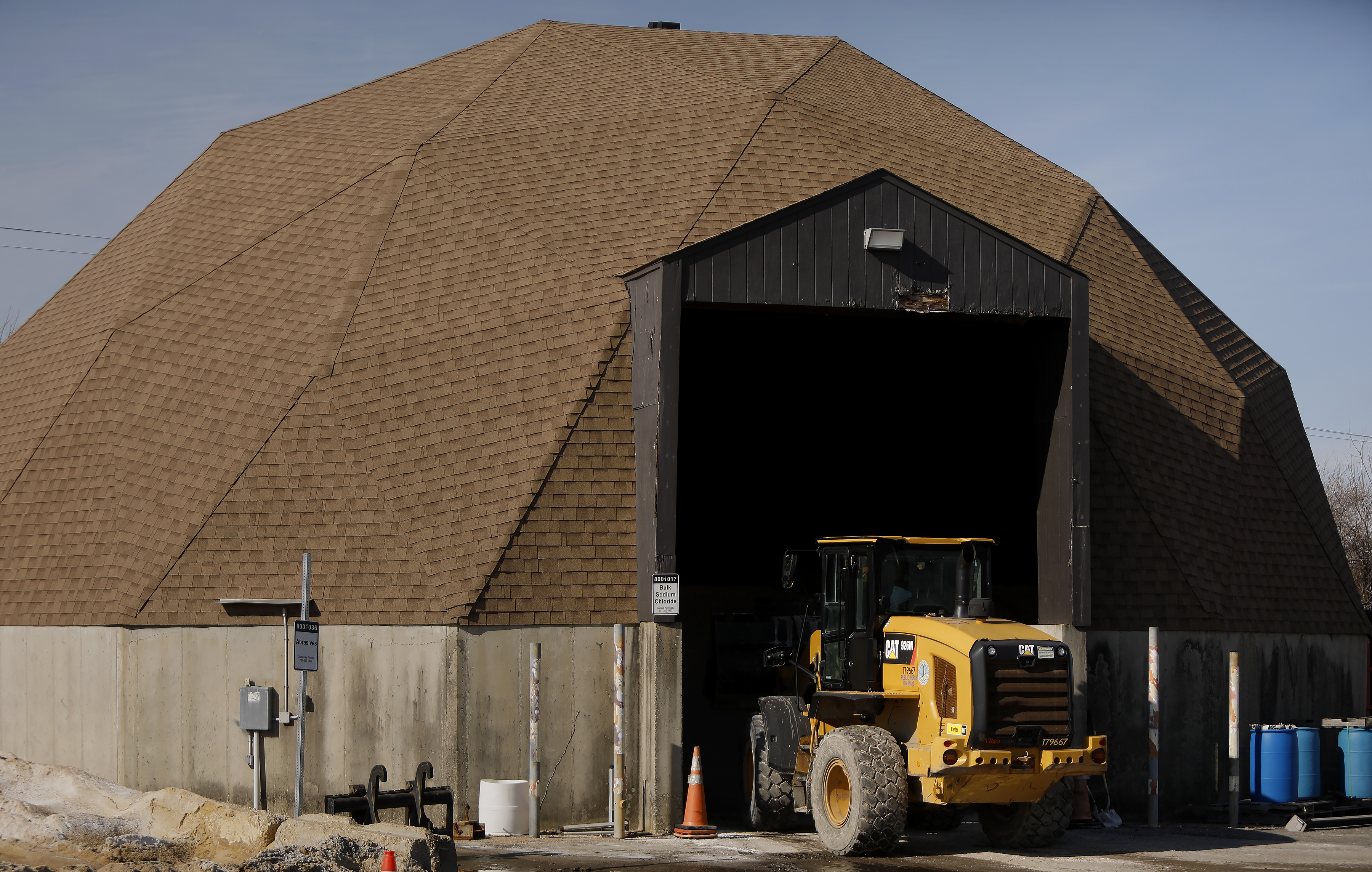 Virginia Beach Public Works employees maneuver bucket loads of salt...