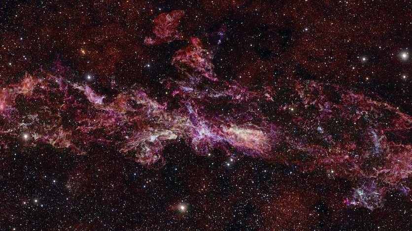 The Milky Way's Central Molecular Zone (CMZ) surrounds our galaxy's supermassive black hole and may share characteristics with the dense and chaotic galaxies of the early universe. This is the largest-ever image taken by the ALMA telescope in Chile.