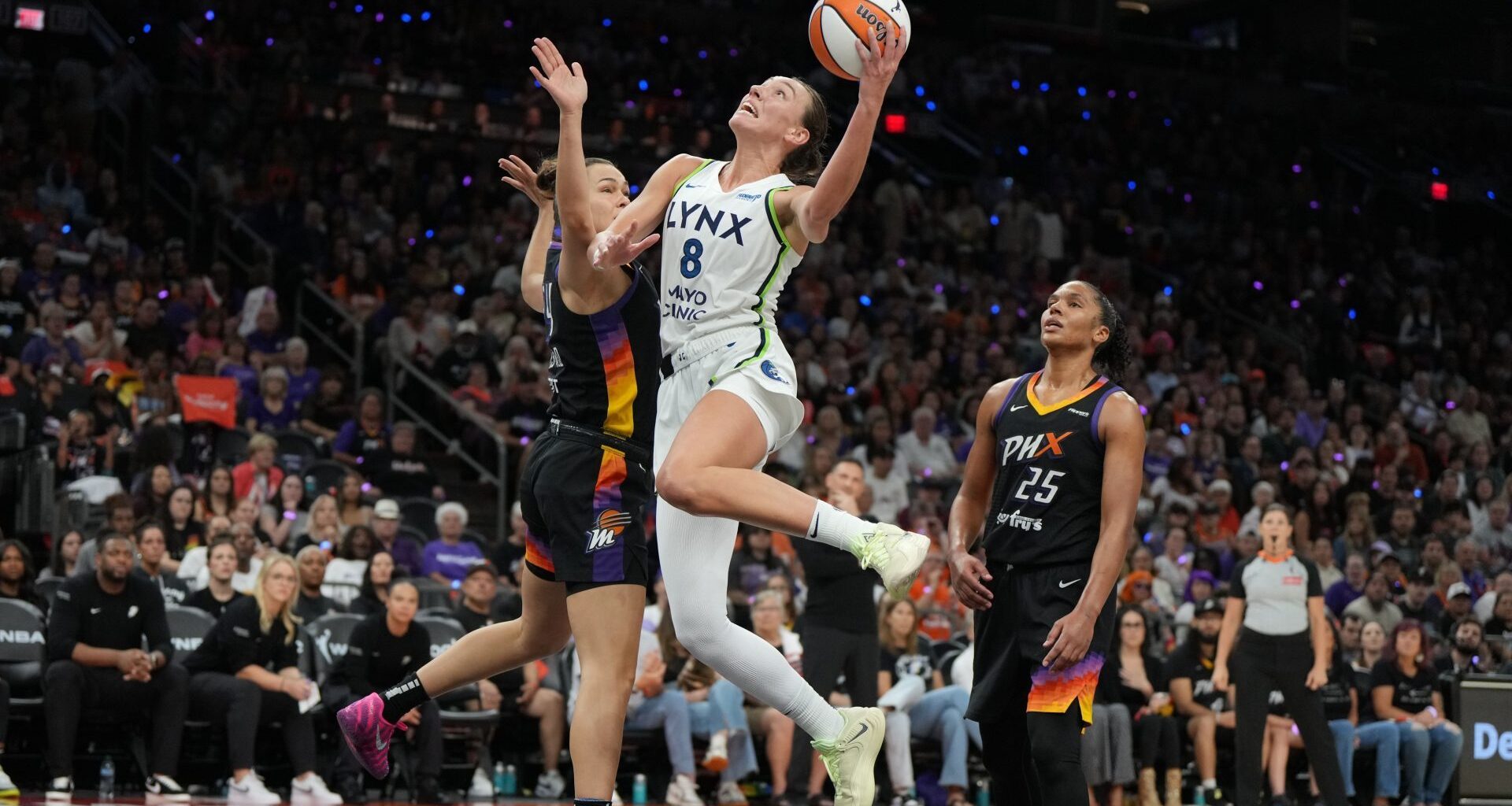 Sep 28, 2025; Phoenix, Arizona, USA; Minnesota Lynx forward Alanna Smith (8) scores on Phoenix Mercury forward Kathryn Westbeld (24) and forward Alyssa Thomas (25) in the second half during game four of the second round for the 2025 WNBA Playoffs at PHX Arena.