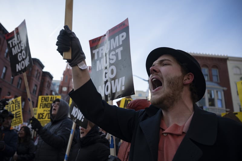 Demonstrators held a rally, holding banners and chanting slogans as they gather to protest against President Donald Trump, ICE raids, arrests, and the Trump administration around the China Town in Washington, DC, on January 30, 2026.