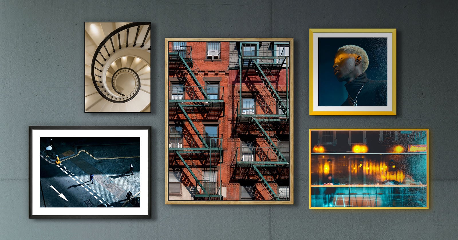 A collage of five framed photos on a gray wall, featuring a spiral staircase, a red brick building with fire escapes, a person with blond hair in dramatic lighting, a city street scene, and reflections of lights in water.