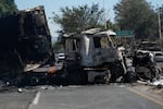A charred truck blocks a road the day after the Mexican army killed Jalisco New Generation Cartel leader Nemesio Oseguera Cervantes, known as "El Mencho," in Guadalajara, Mexico, Monday, Feb. 23, 2026.
