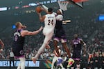 Minnesota Timberwolves forward Jaden McDaniels, center right, tries to block a shot by Portland Trail Blazers forward Kris Murray (24) during the first half of an NBA basketball game Tuesday, Feb. 24, 2026, in Portland, Ore.