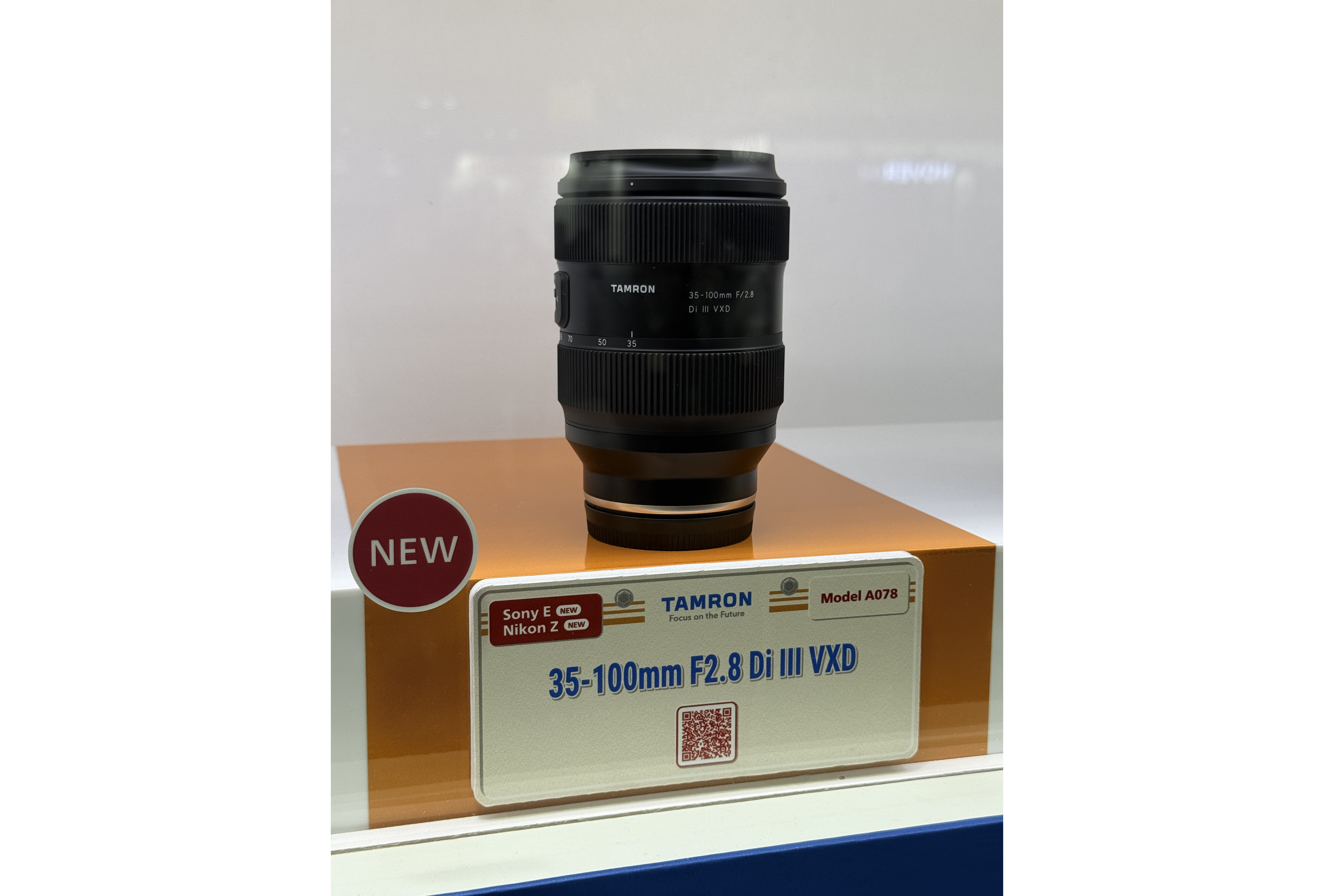 The Tamron 35-100mm f/2.8 zoom lens on display at the Tamron booth at the CP+ 2026 show