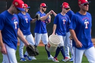 Texas Rangers outfielder Brandon Nimmo (center) fist bumps first base coach Travis Jankowski...