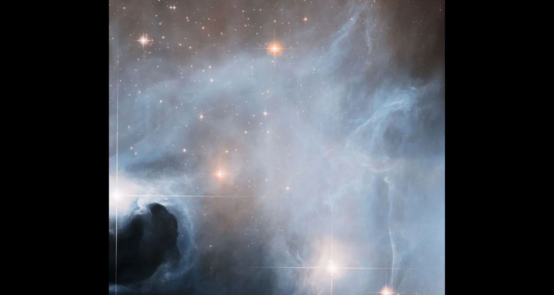 Photo numerous bright stars in space covered in think swirls of gray and white clouds.