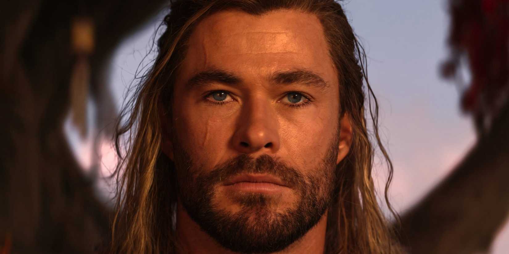 Chris Hemsworth looking into the camera with a blank stare in Thor: Love and Thunder