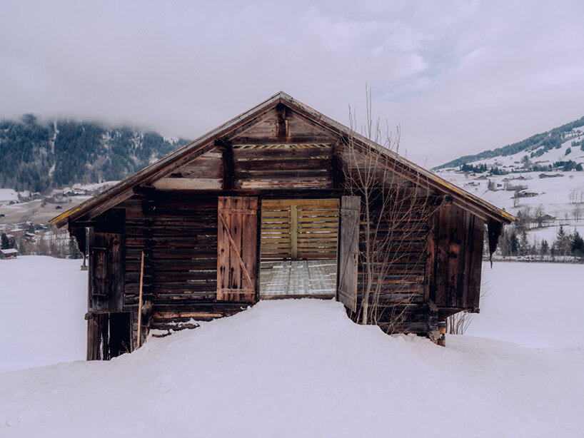 alexandre de betak inserts reflective light installation into traditional swiss barn