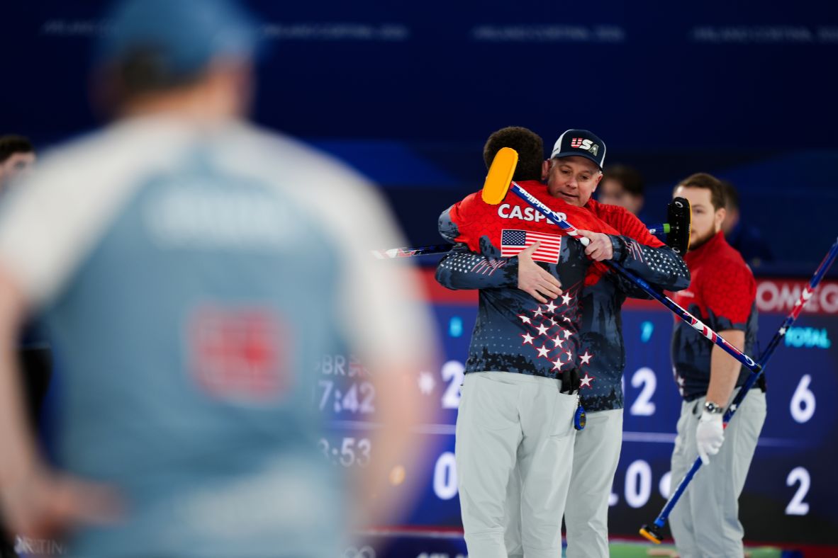 American curler Rich Ruohonen is embraced by teammates after a game against Switzerland on February 12. Team USA lost 8-3, but Ruohonen made history. At 54, he is officially <a href=