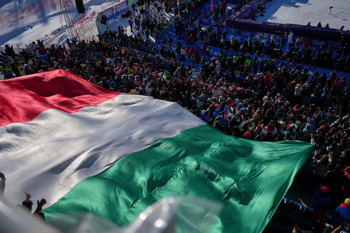 A giant Italian flag is displayed by fans during the medal ceremony where Italy's Federica Brignone won the gold medal in an alpine ski women's giant slalom race on February 15.