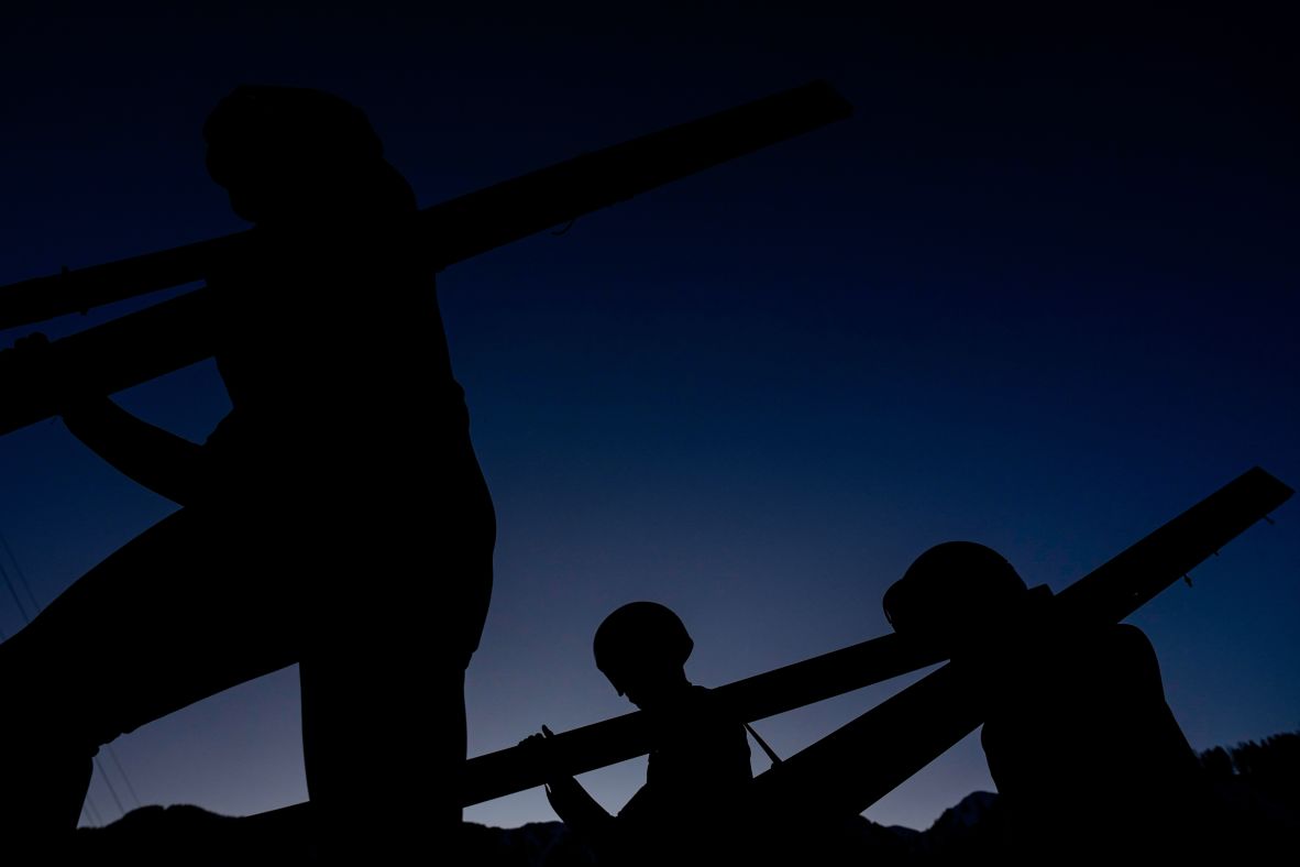 Athletes make their way to the ramp for the men's super team ski jumping on February 16.