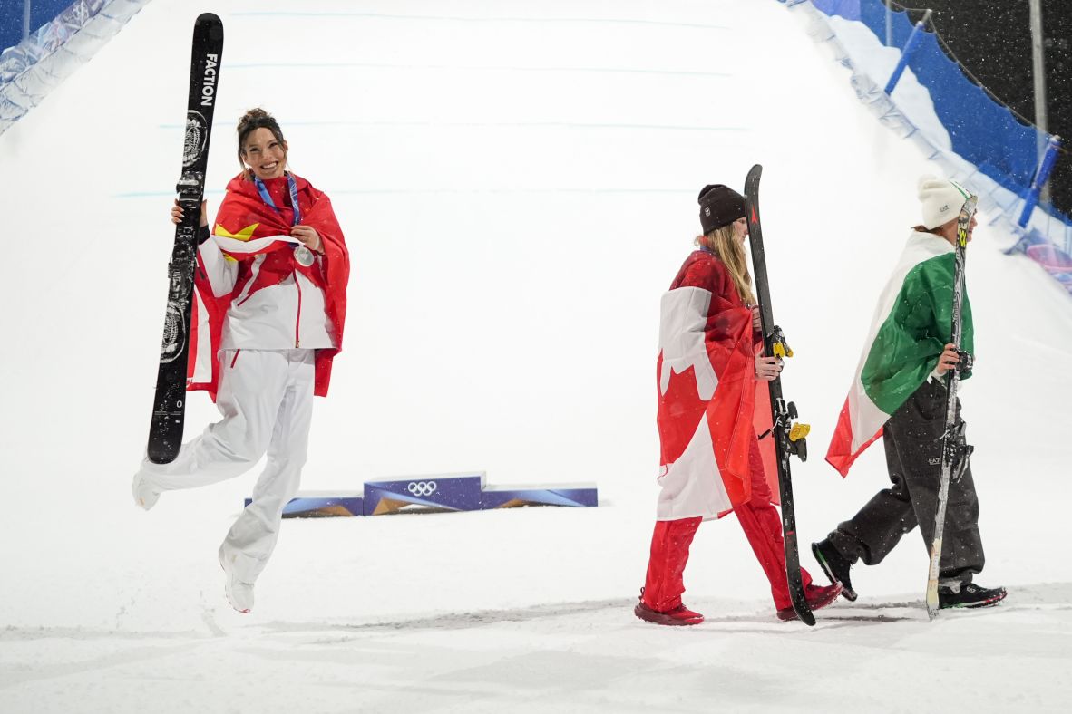 Silver medalist Eileen Gu of China, left, celebrates as gold medalist Megan Oldham of Canada and bronze medalist Flora Tabanelli of Italy walk off after the <a href=