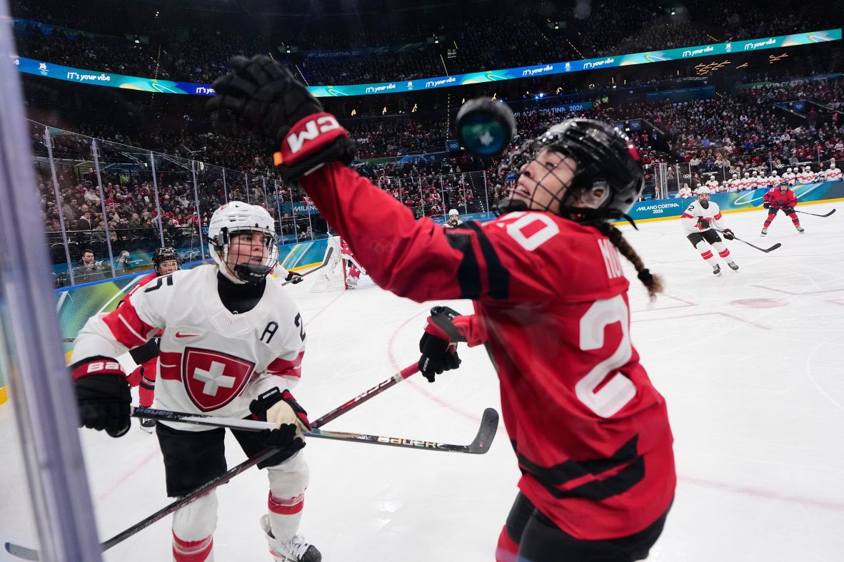 Switzerland's Alina Muller, left, challenges Canada's Sarah Nurse for the puck in the women's hockey semifinals on February 16. <a href=
