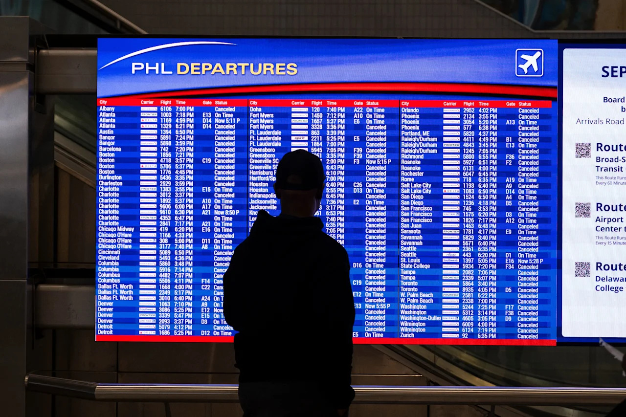 A traveler checks departure times.