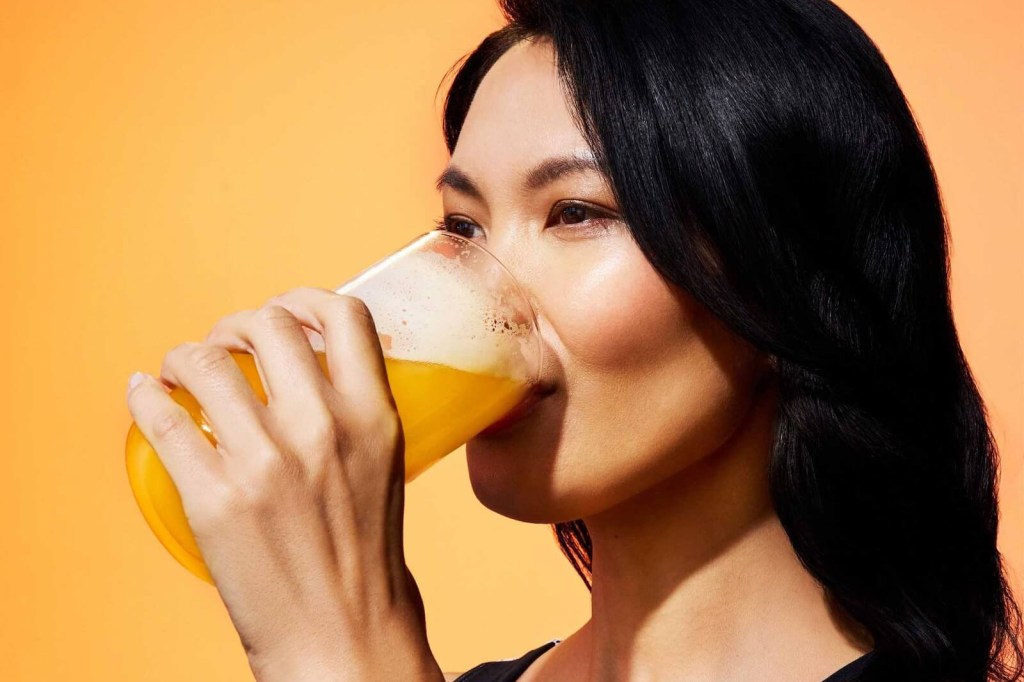 Woman drinking ARMRA colostrum supplement