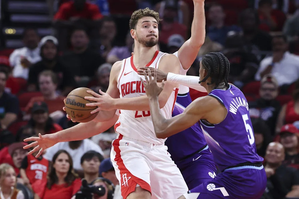 Oct 8, 2025; Houston, Texas, USA; Houston Rockets center Alperen Sengun (28) controls the ball as Utah Jazz forward Cody Williams (5) defends during the second quarter at Toyota Center. Mandatory Credit: Troy Taormina-Imagn Images