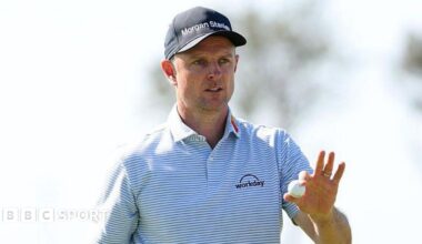 Justin Rose holds a golf ball up