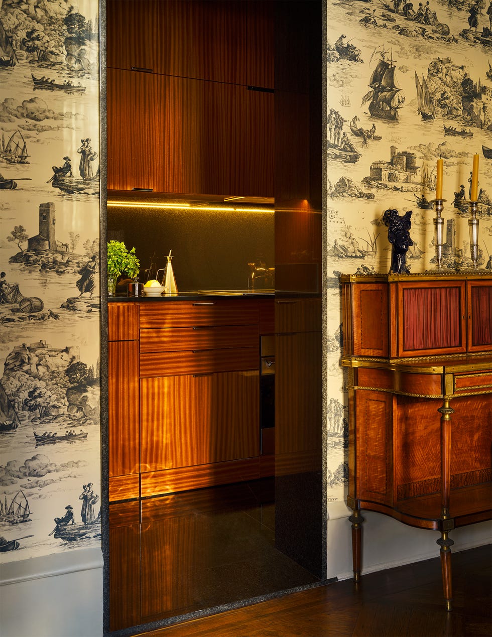 Modern kitchen nook with elegant wood finishes and decorative wall.