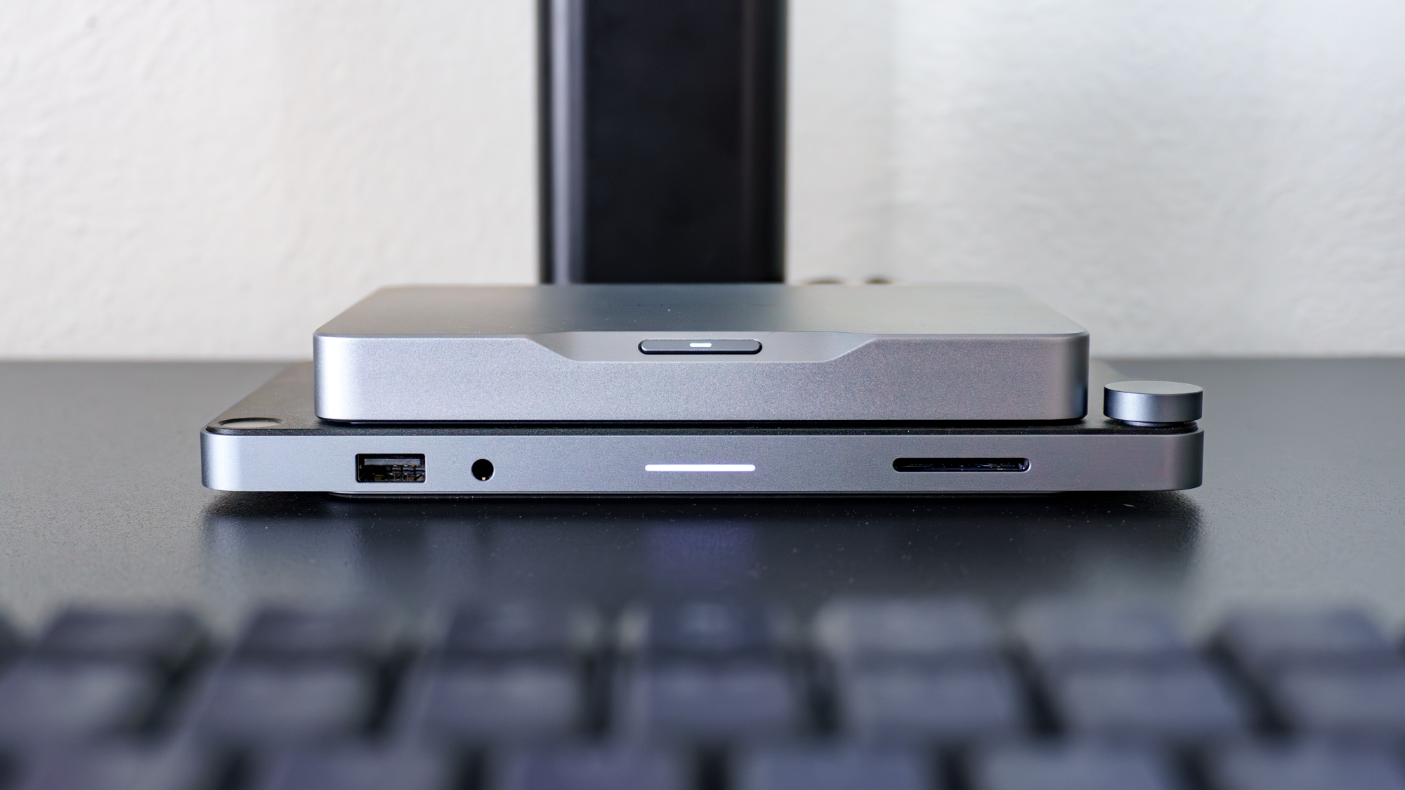 The Khadas Mind 2S on a desk with the optional Mind Dock attached underneath it