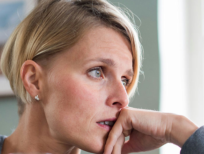 Woman with short blonde hair looking thoughtfully out a window, a relatable moment for weirdly hilarious images.