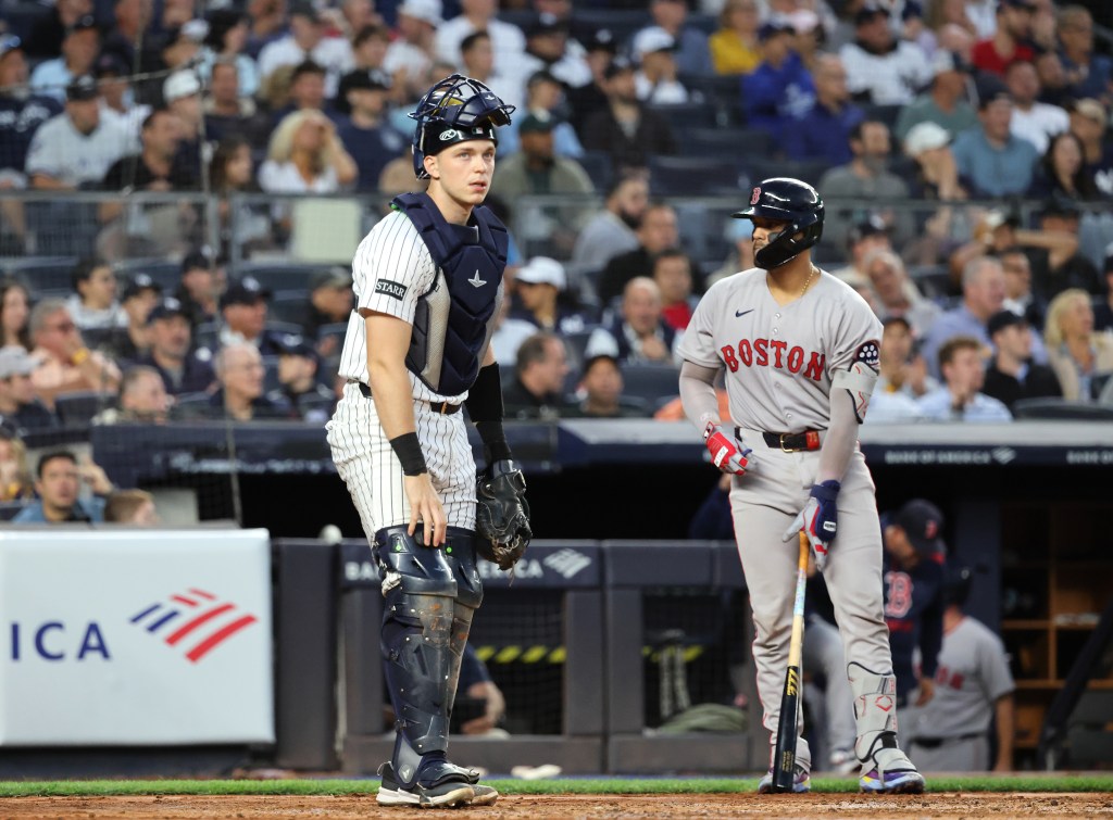 New York Yankees catcher Ben Rice #22 reacts after making a throwing error against the Boston Red Sox.