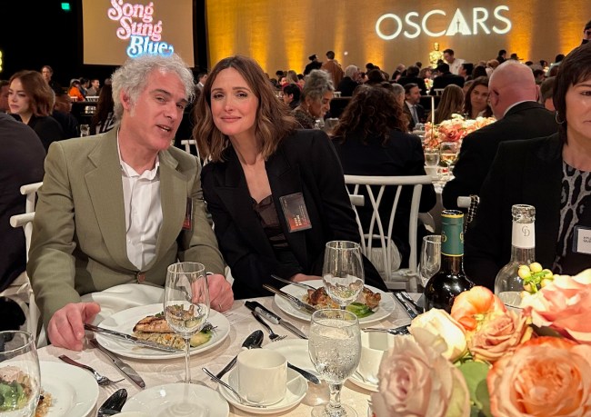 Ronald Bronstein, writer of nominated "Marty Supreme," sits with his wife Mary Bronstein's "If I Had Legs I'd Kick You" star Rose Byrne. 