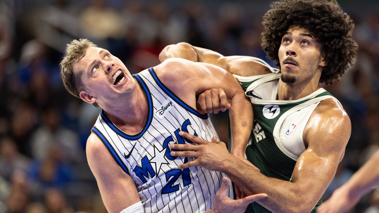 Orlando Magic forward/center Moritz Wagner, left, and Milwaukee Bucks center Jericho Sims fight for position on a rebound during the first half of an NBA basketball game, Wednesday, Feb. 11, 2026, in Orlando, Fla.